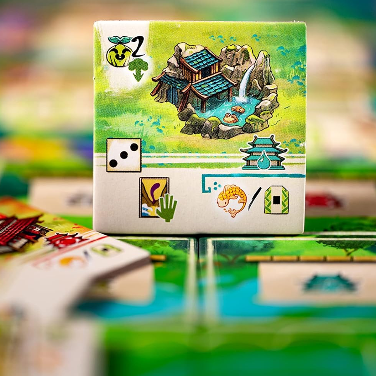 Bitoku Board Game - A Colourful Tile Example Close-Up on a Blurred Background | Happy Piranha