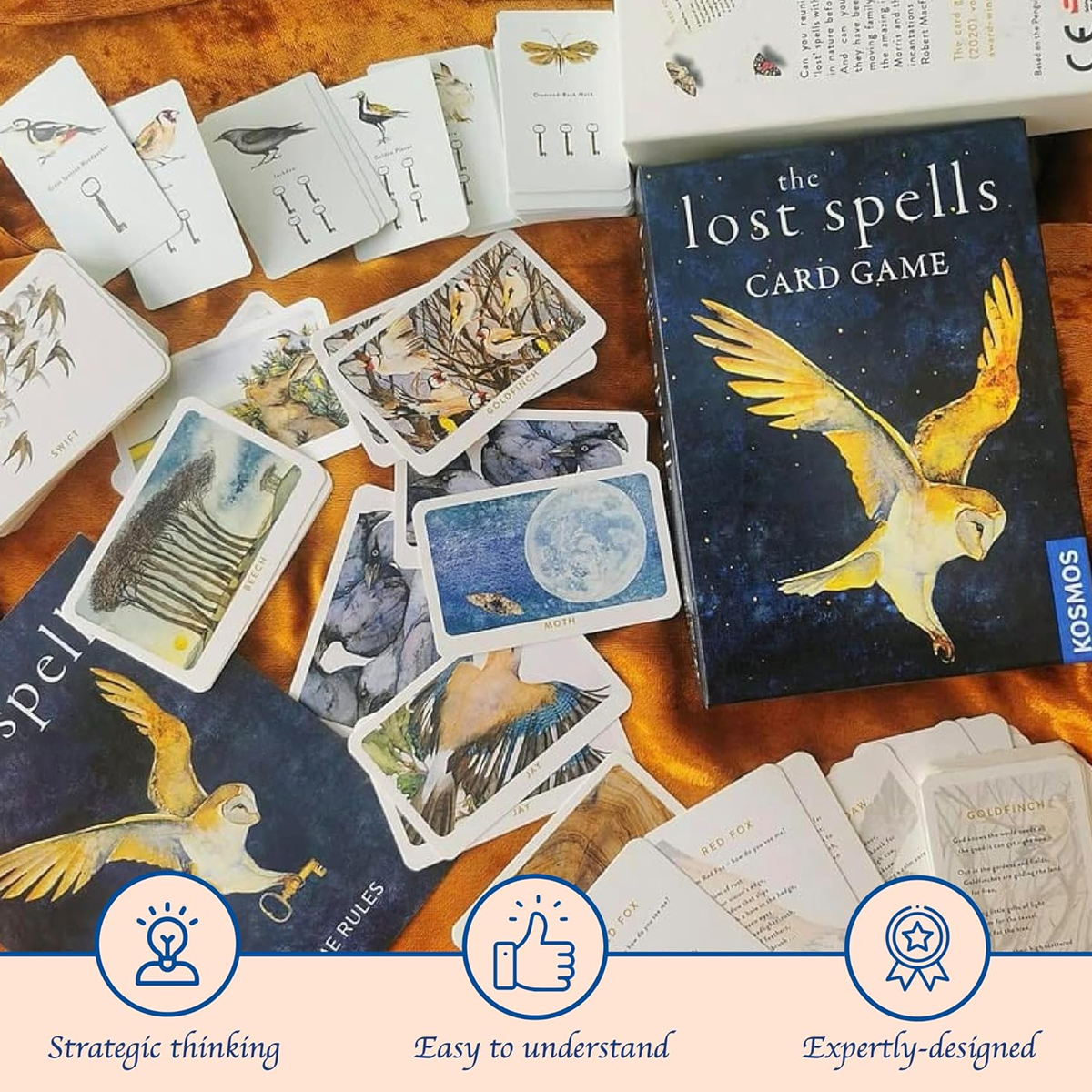 The Lost Spells Card Game Box and Components Spread Out on a Wooden Table | Happy Piranha