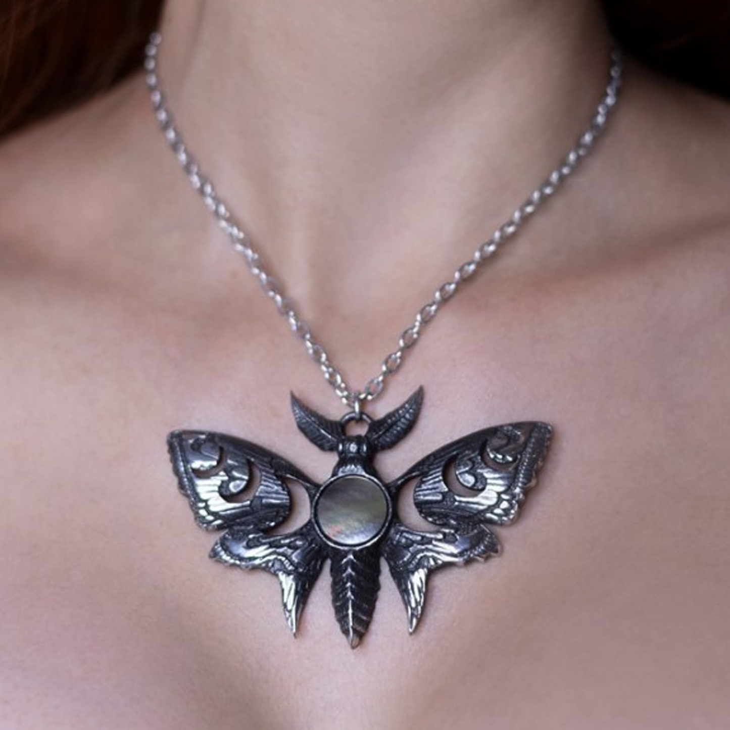 Lunar Moth - Pewter & Mother of Pearl Pendant Necklace Being Worn Around a Woman's Neck Close Up | Happy Piranha