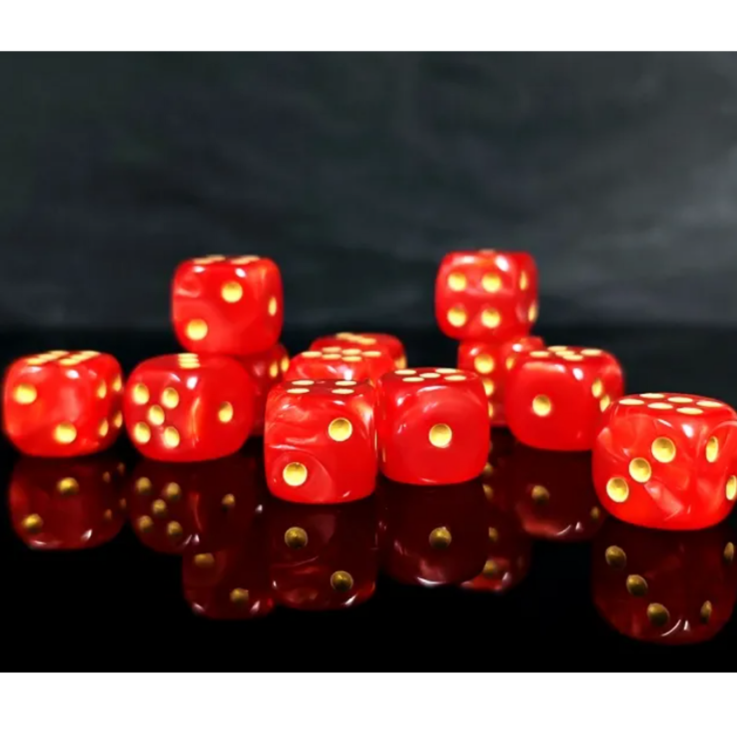 Red dice with gold dots on a reflective black surface | Happy Piranha