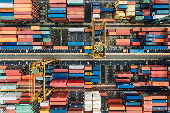 A view of lots of colourful shipping containers from above.