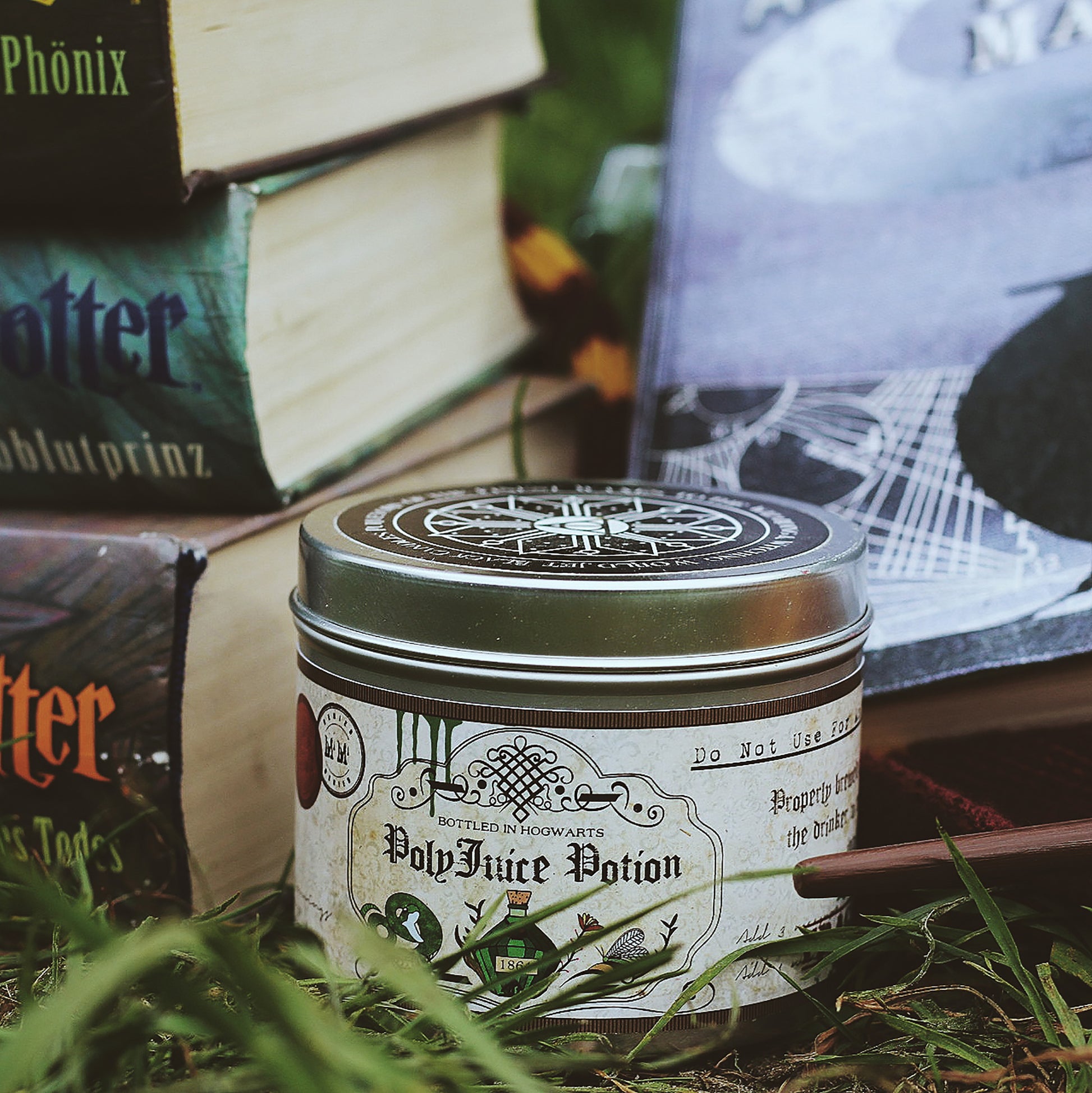 Happy Piranha's polyjuice potion candle in the grass with books.