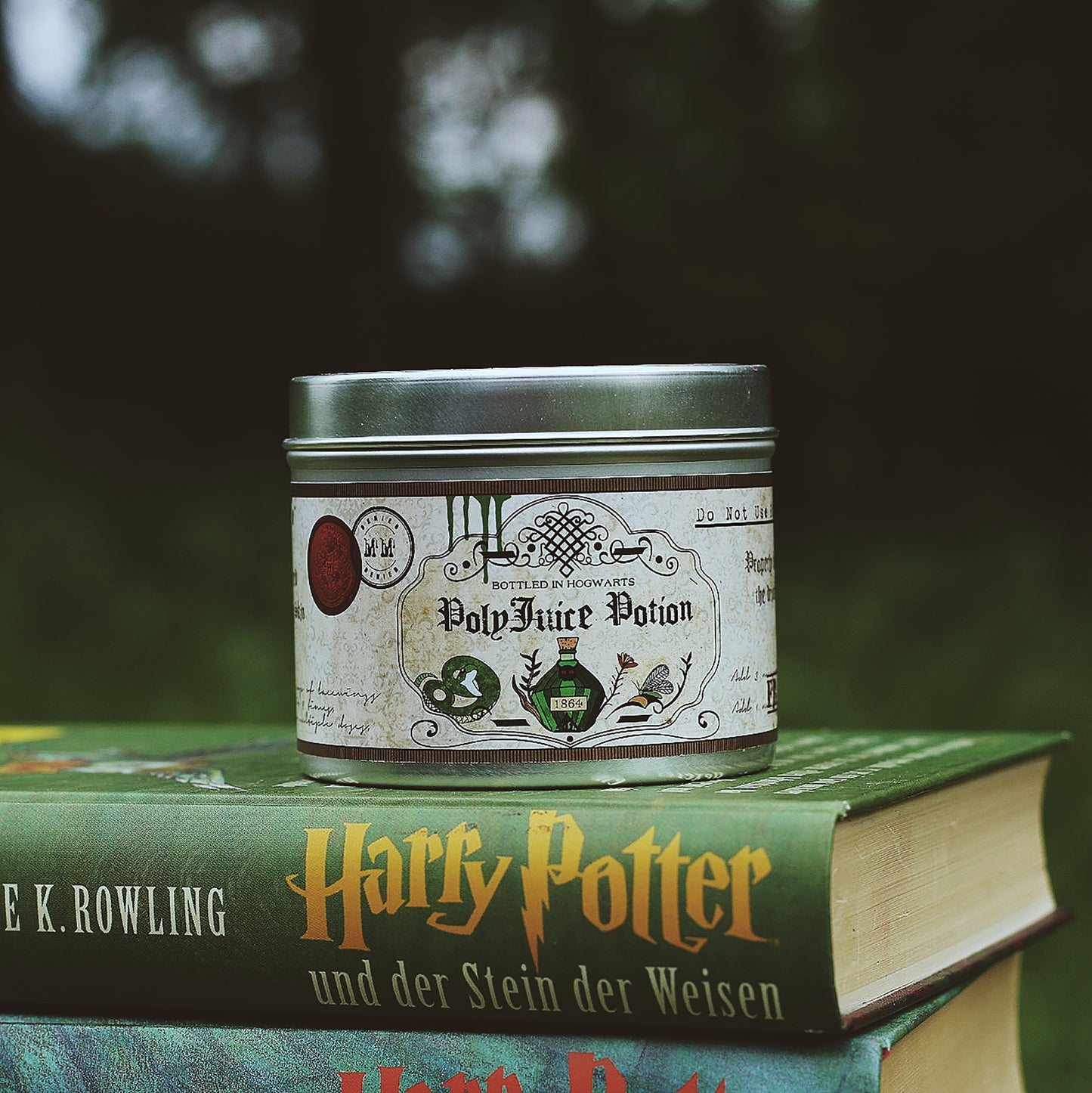 Polyjuice Potion scented candle on top of Harry Potter books.