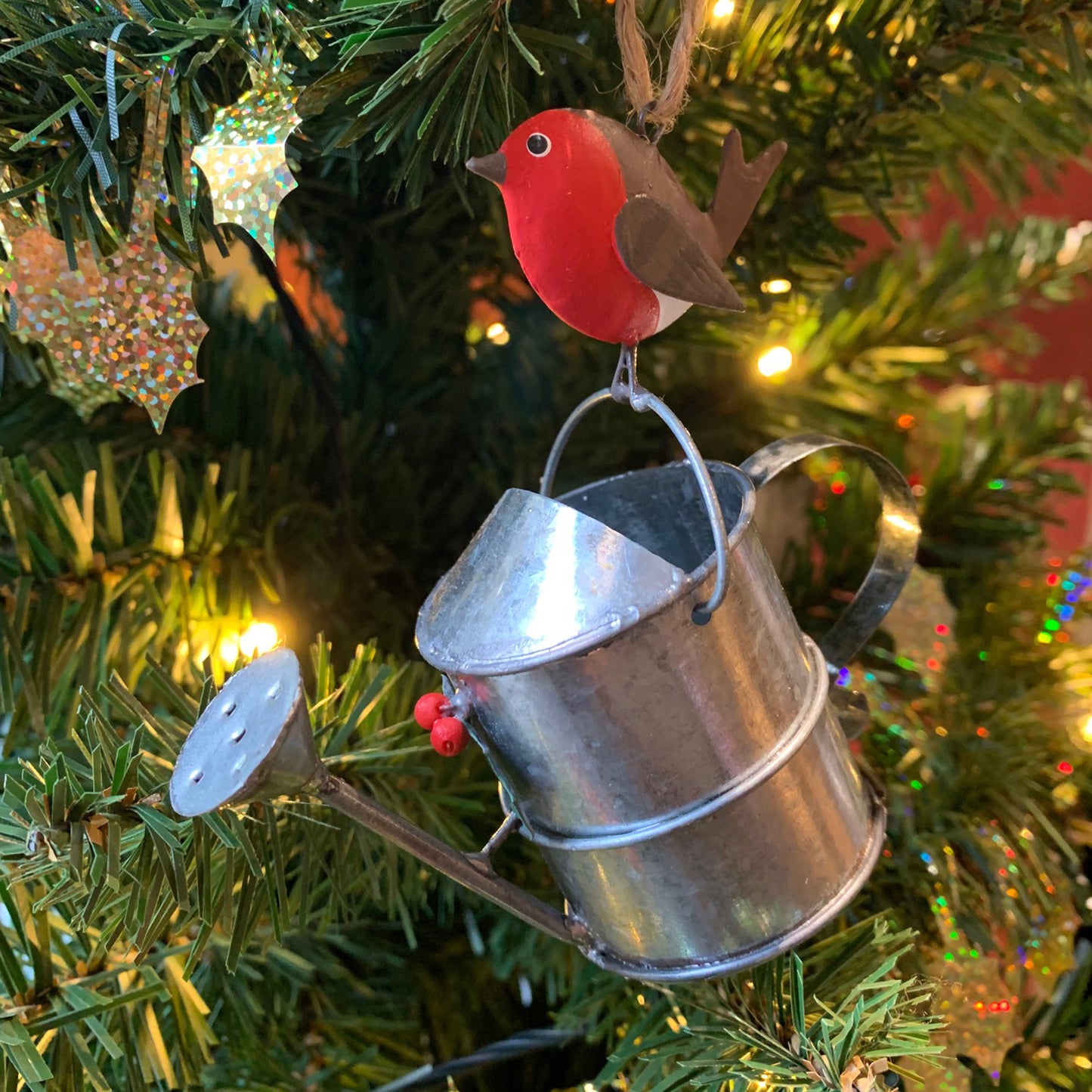 Robin on a Watering Can Hanging Christmas Decoration in a Christmas Tree | Happy Piranha