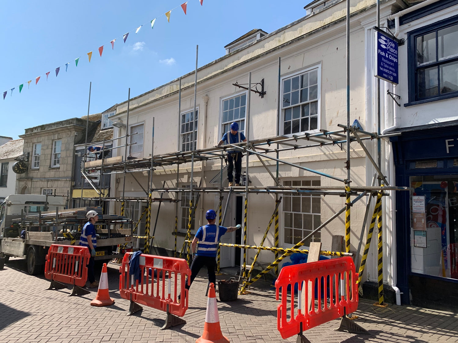 Scaffolders working on the outside of Happy Piranha Café in Truro, Cornwall. 