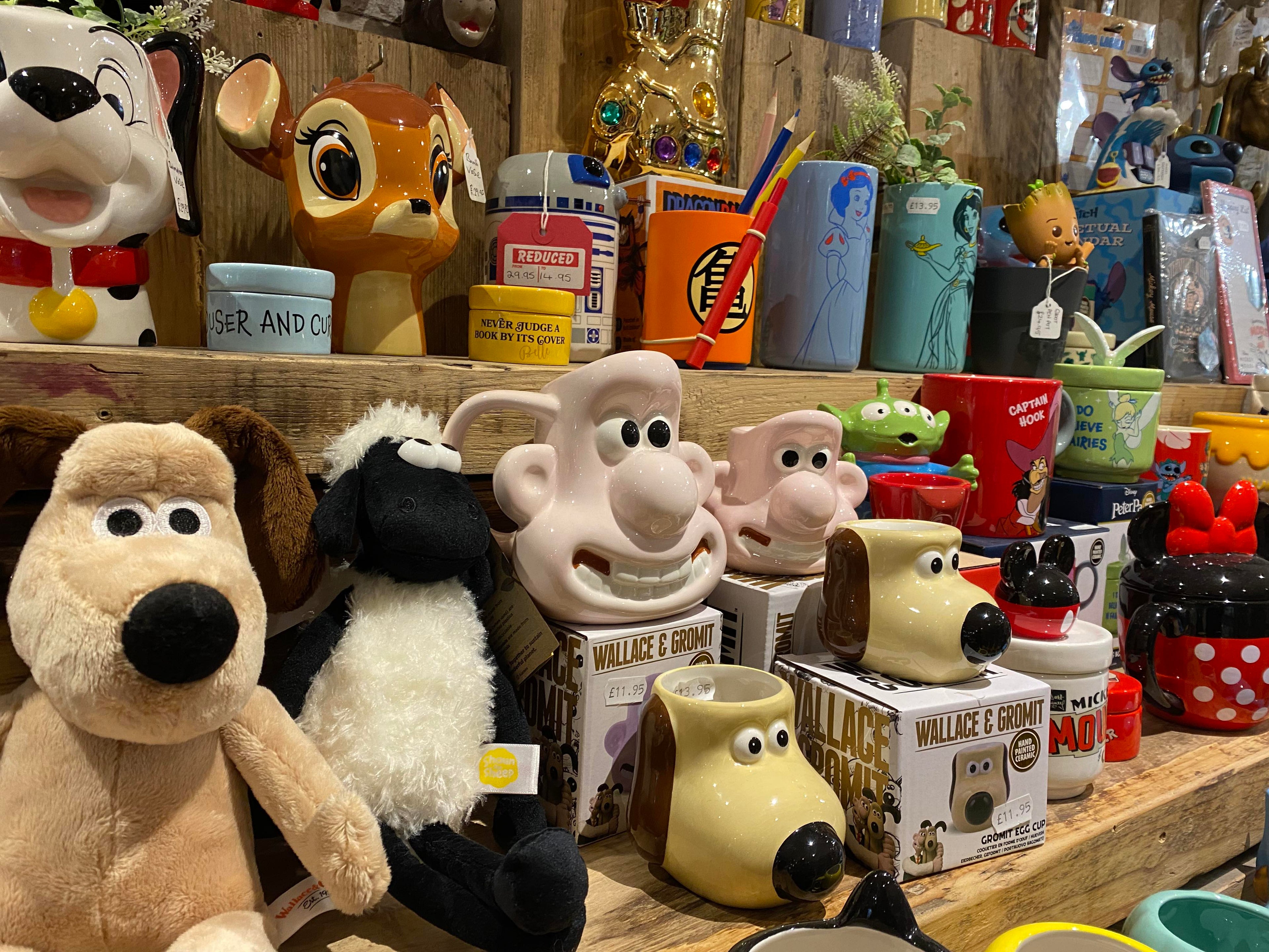 One of the shelves at Happy Piranha store featuring a selection of Disney and Wallace & Gromit merchandise.