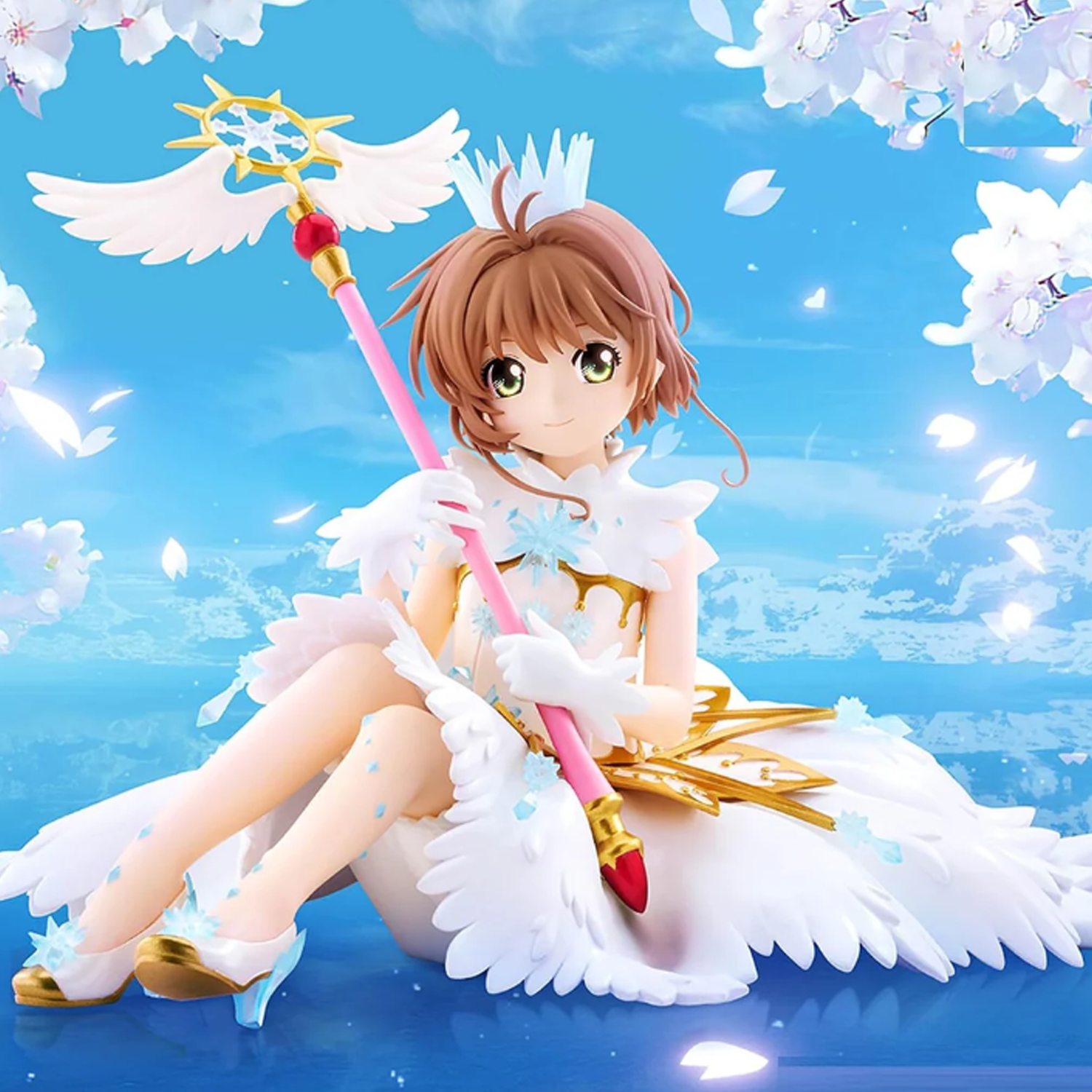 A stylized anime figurine of a young girl with short auburn hair, seated cross-legged in a white angel-inspired dress with white wings, holding a pink and gold staff with a blue star emblem. The background is a bright blue sky with white cherry blossoms and petals |  Sakura Kinomoto: Cardcaptor Sakura Clear Card Figure | Happy Piranha