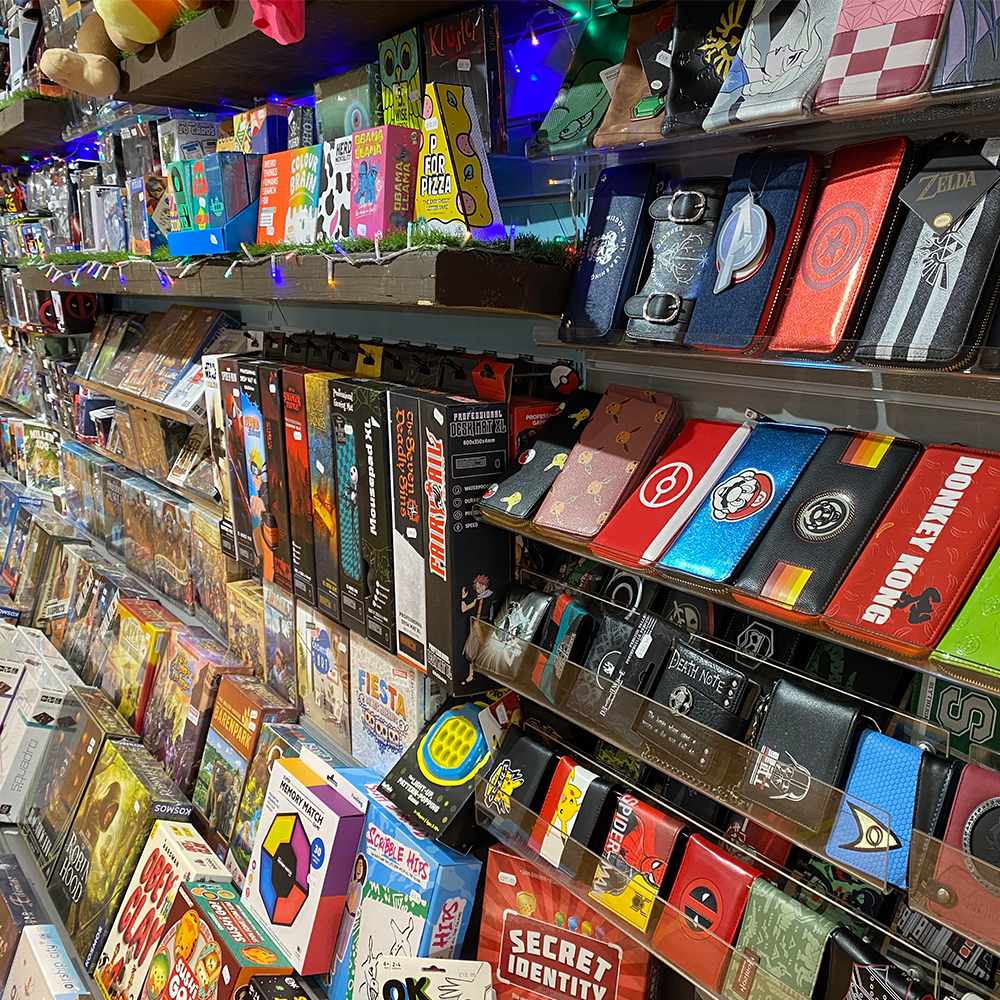 A shelf full of colourful wallets, purses and board games at the Happy Piranha store.