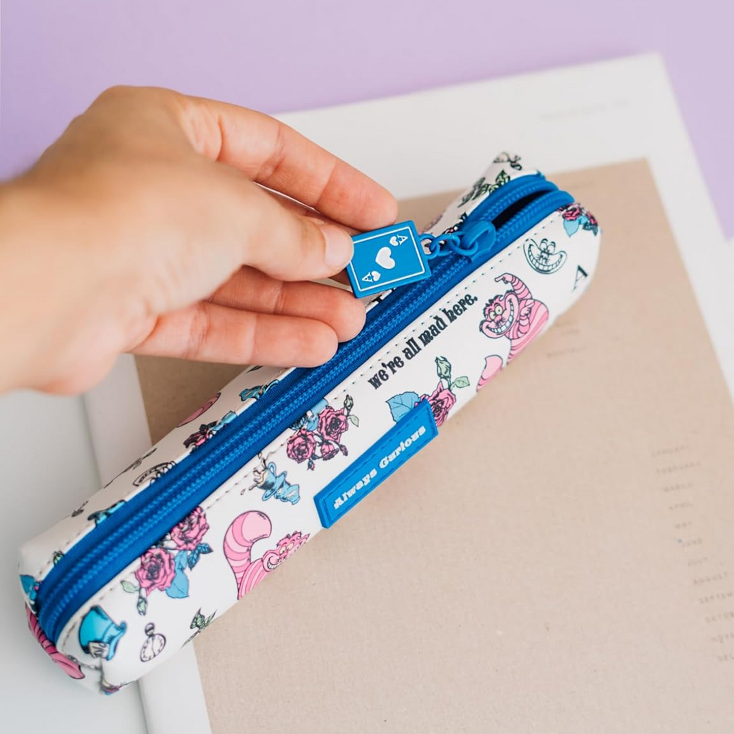 A Hand Holding the Ace of Spades Shaped Zipper on an Alice in Wonderland Design Mini Pen & Pencil Case | Happy Piranha