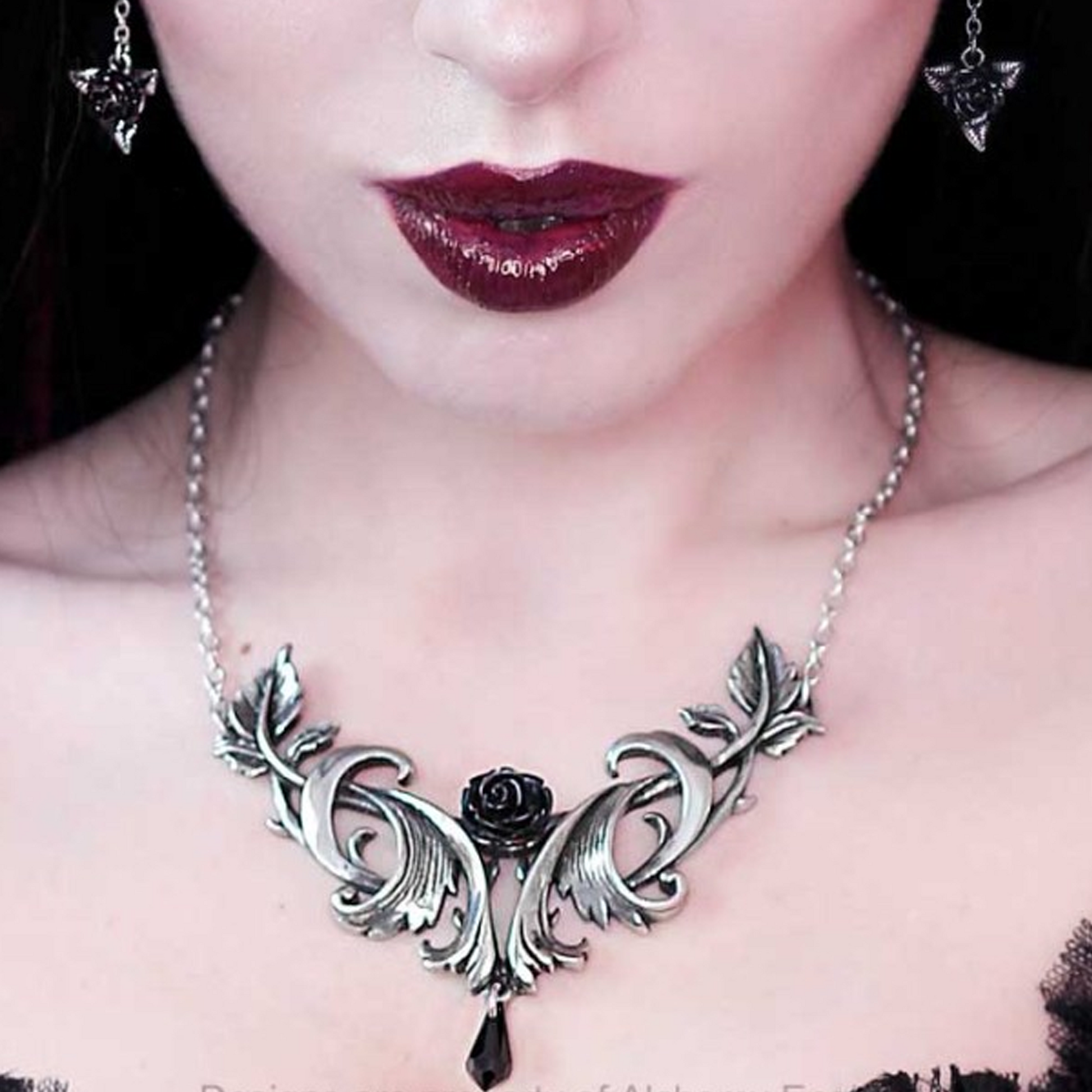 A Woman on a Dark Background Close Up with Dark Red Lipstick, Wearing the Baroque Rose - Pewter & Black Crystal Gothic Design Necklace  and a Black Dress | Happy Piranha