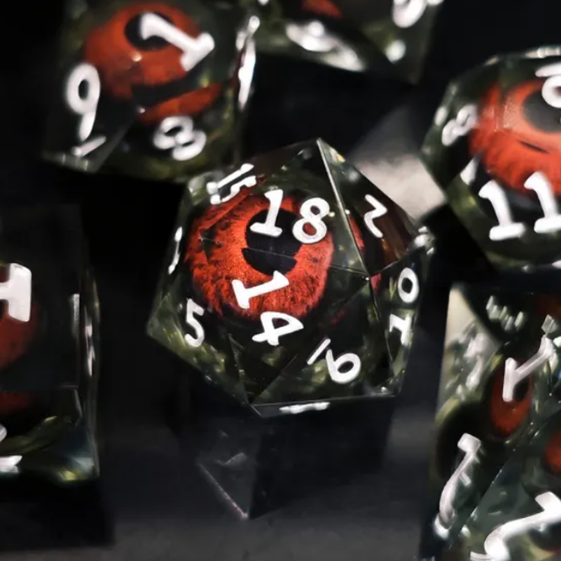 Black Rolling Eyes: Liquid Core Sharped Edged Polyhedral Dice Set- Close up of the D20 on a Black Background | Happy Piranha