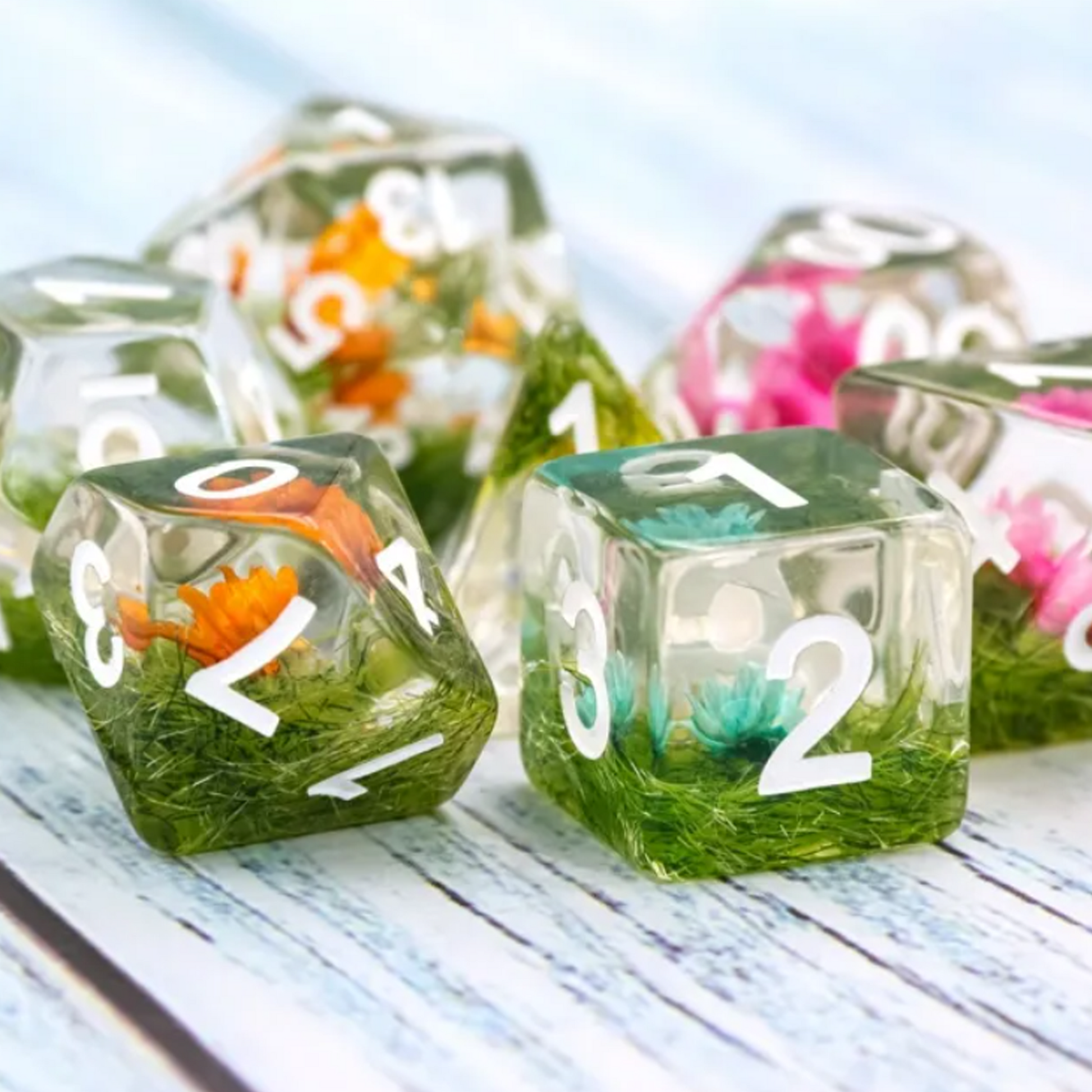 Blossom Dice - Flower Filled Polyhedral D&D Dice Set in a Pile on a Table | Happy Piranha