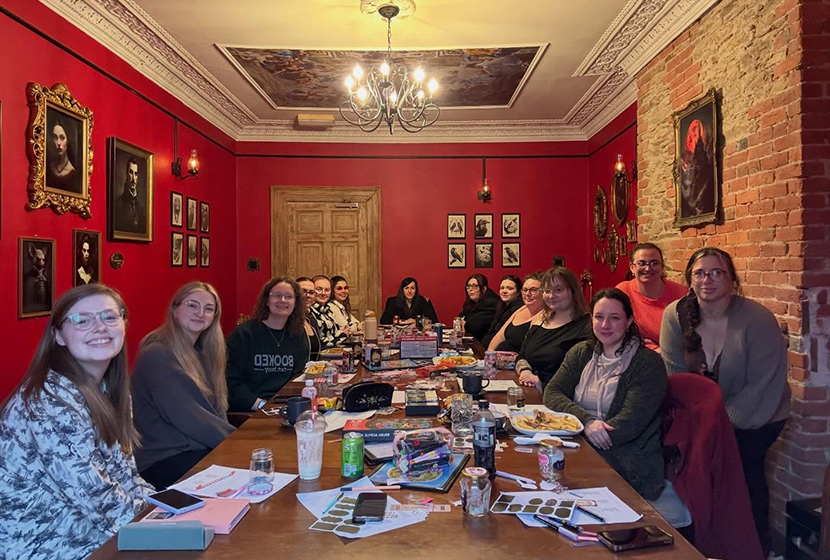 A group of readers discussing a book in the Vampire Dining Hall at Piranha Café