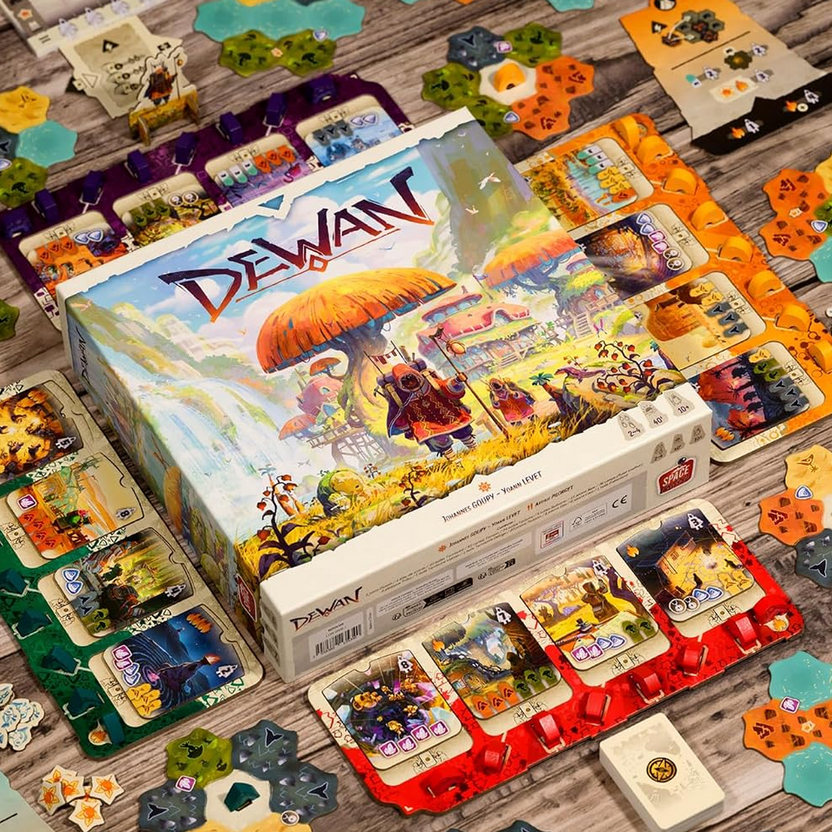Dewan Board Game (Box With Components Laid Out Around the Outside) on a Wooden Table | Happy Piranha