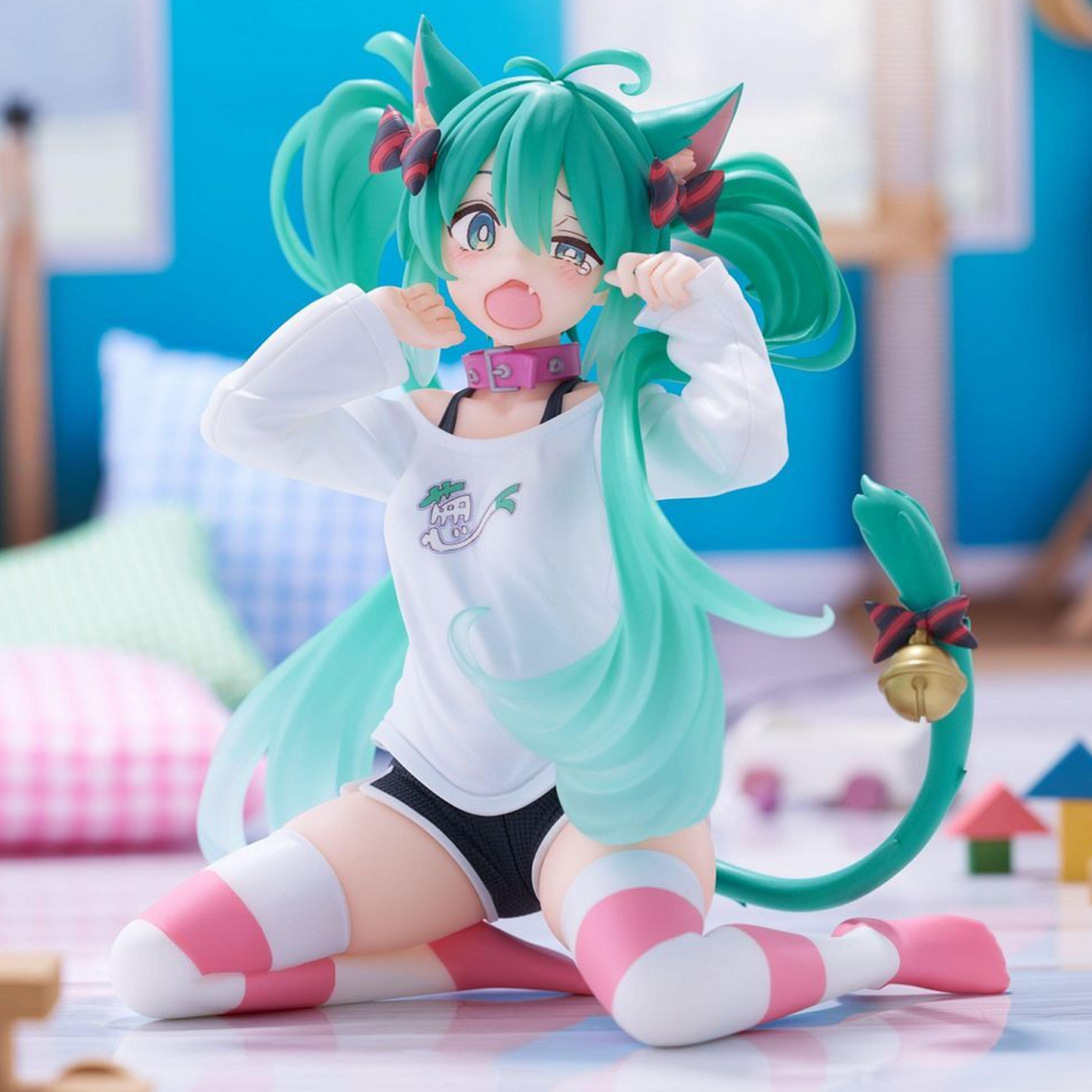 An anime-style collectible figurine of a character with long teal twin buns, a teal tail with a gold bell, a white long-sleeve top with a small chest graphic, black shorts, and pink-and-white thigh-high socks, posed kneeling in a brightly lit room with soft-focus colorful background elements |  | Happy Piranha