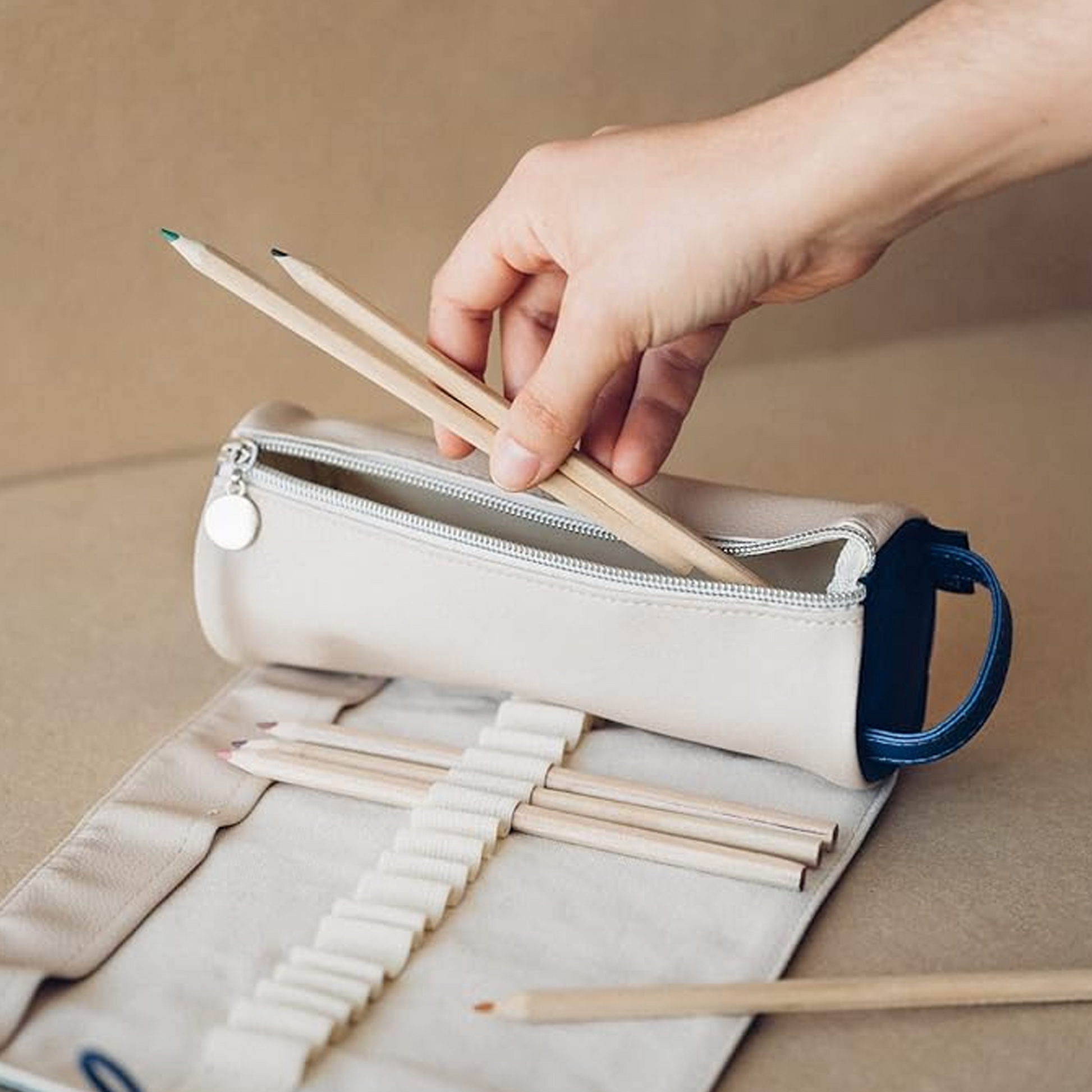 A Person Butting Some Pencils in a Hokusai Great Wave Roll Up Pencil Case / Art Case | Happy Piranha