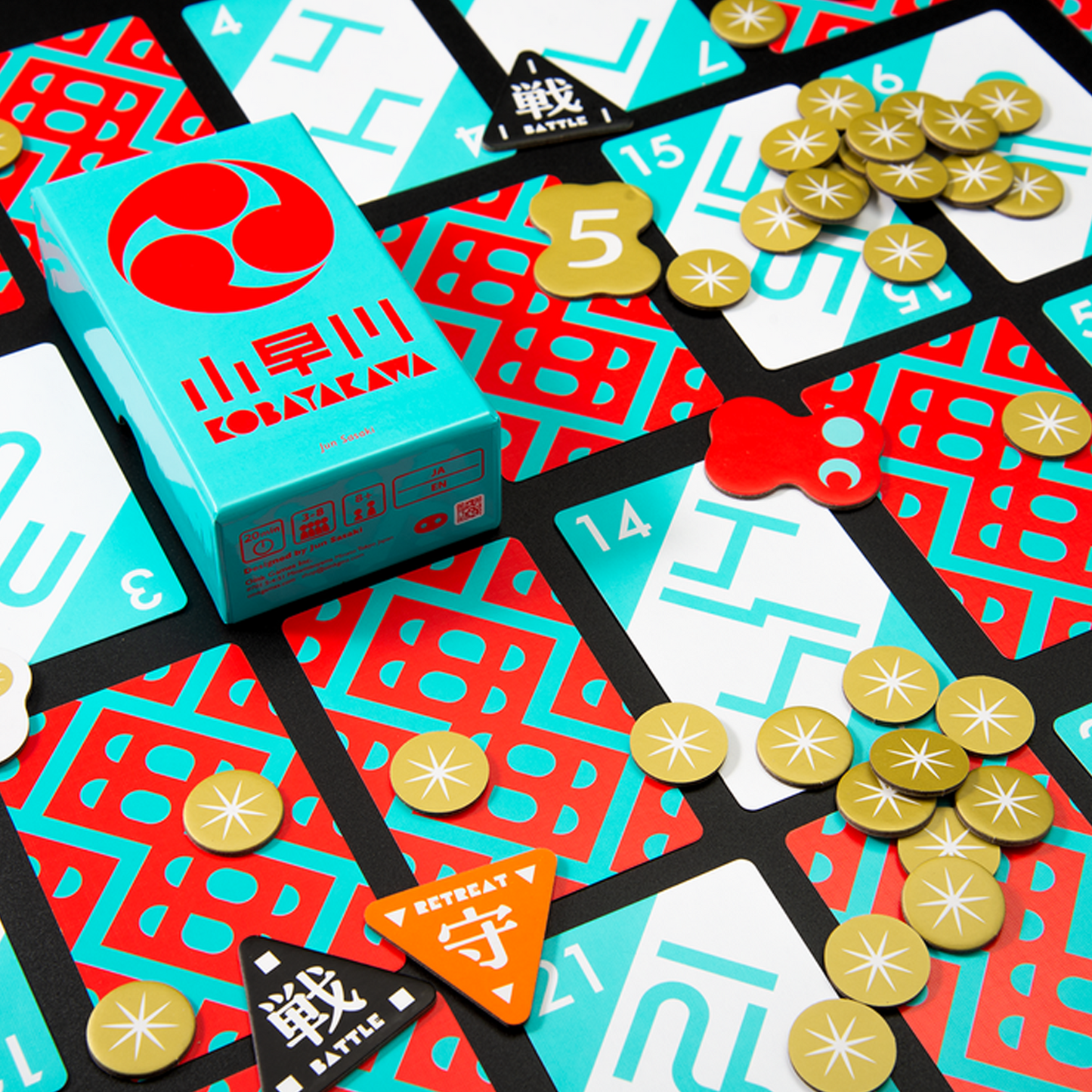 Kobayakawa Board Game, box and components laid out neatly on a black background | Happy Piranha