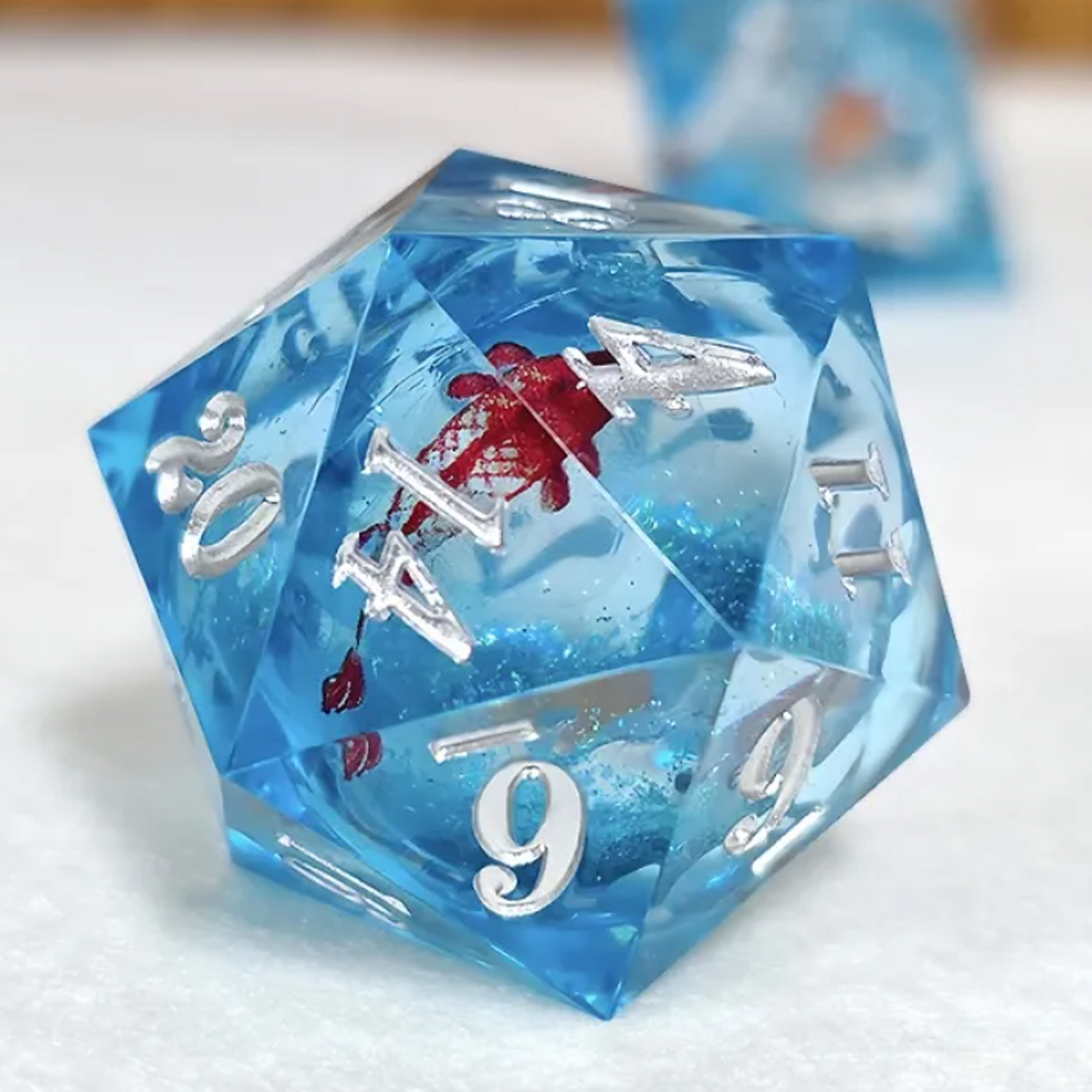 Koi Fish Liquid Core Sharp Edged Polyhedral Glitter D20 Close up on a White Background | Happy Piranha