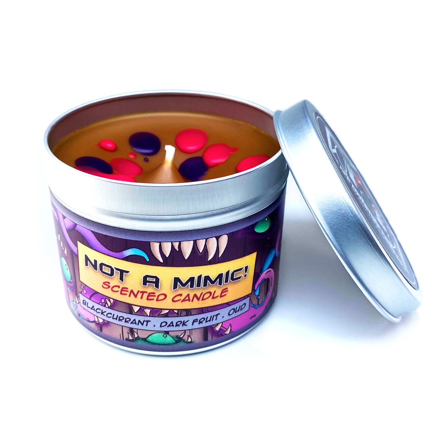 Not a Mimic! Dungeons & Dragons Inspired Scented Candle With its lid Removed, Showing Brown Wax with Pink and Purple Splats on a White Background | Happy Piranha