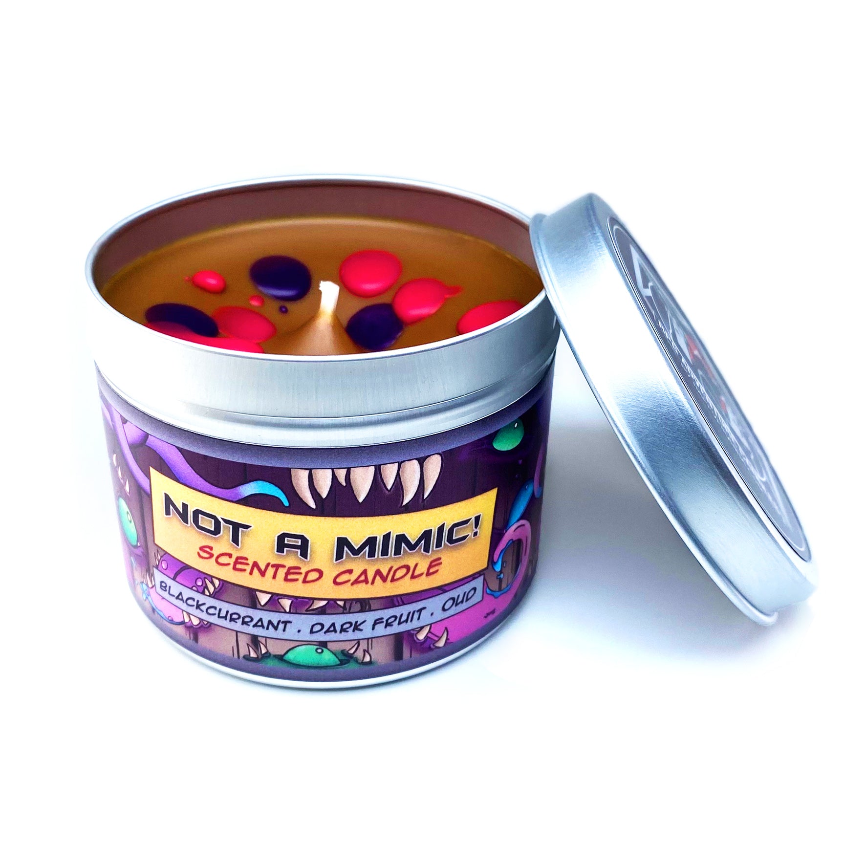 Not a Mimic! Dungeons & Dragons Inspired Scented Candle With its lid Removed, Showing Brown Wax with Pink and Purple Splats on a White Background | Happy Piranha