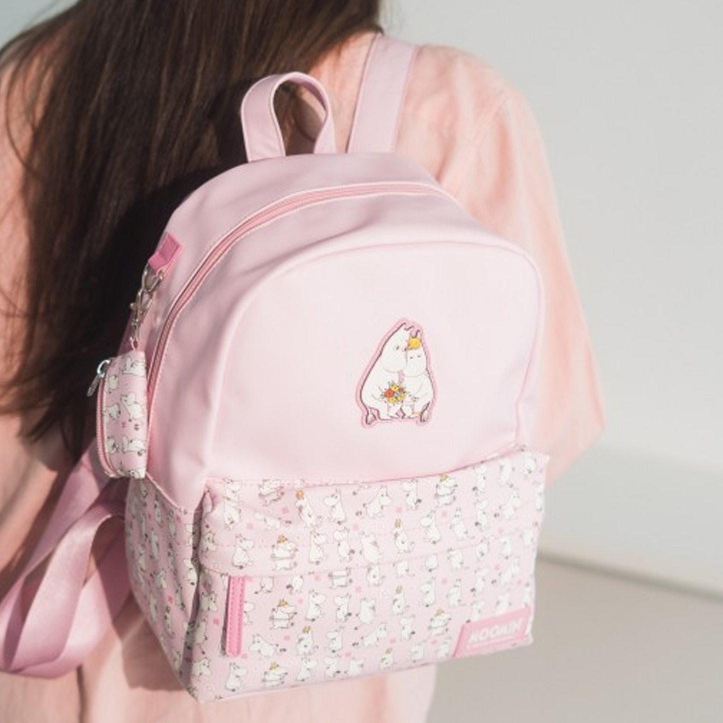 Moomin Backpack: Pink Finn Family Moomin Troll Bag on a Girl's Shoulder | Happy Piranha
