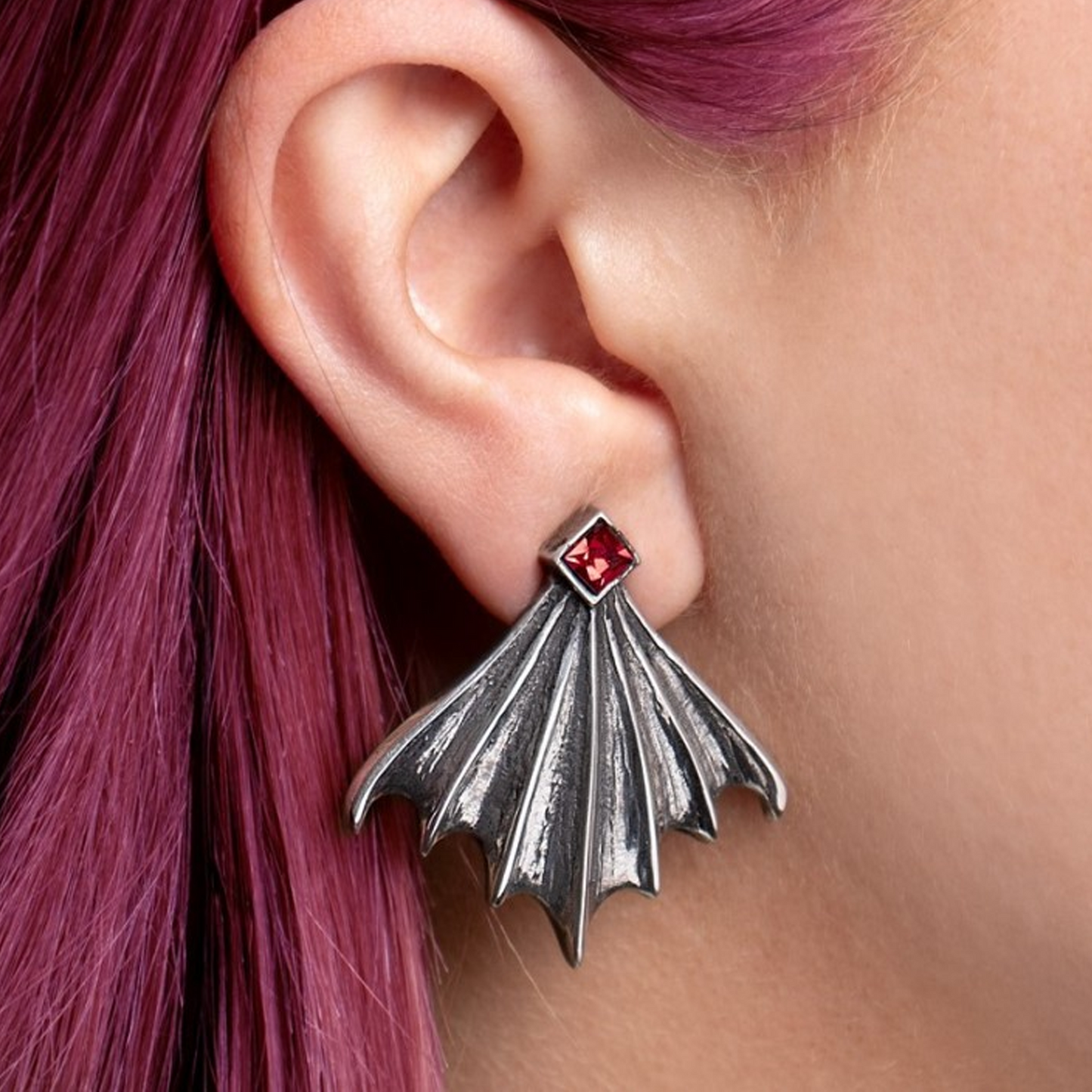 Nighttime - Pewter Gothic Bat Wing Design Stud Earrings on a Person's Ear | Happy Piranha