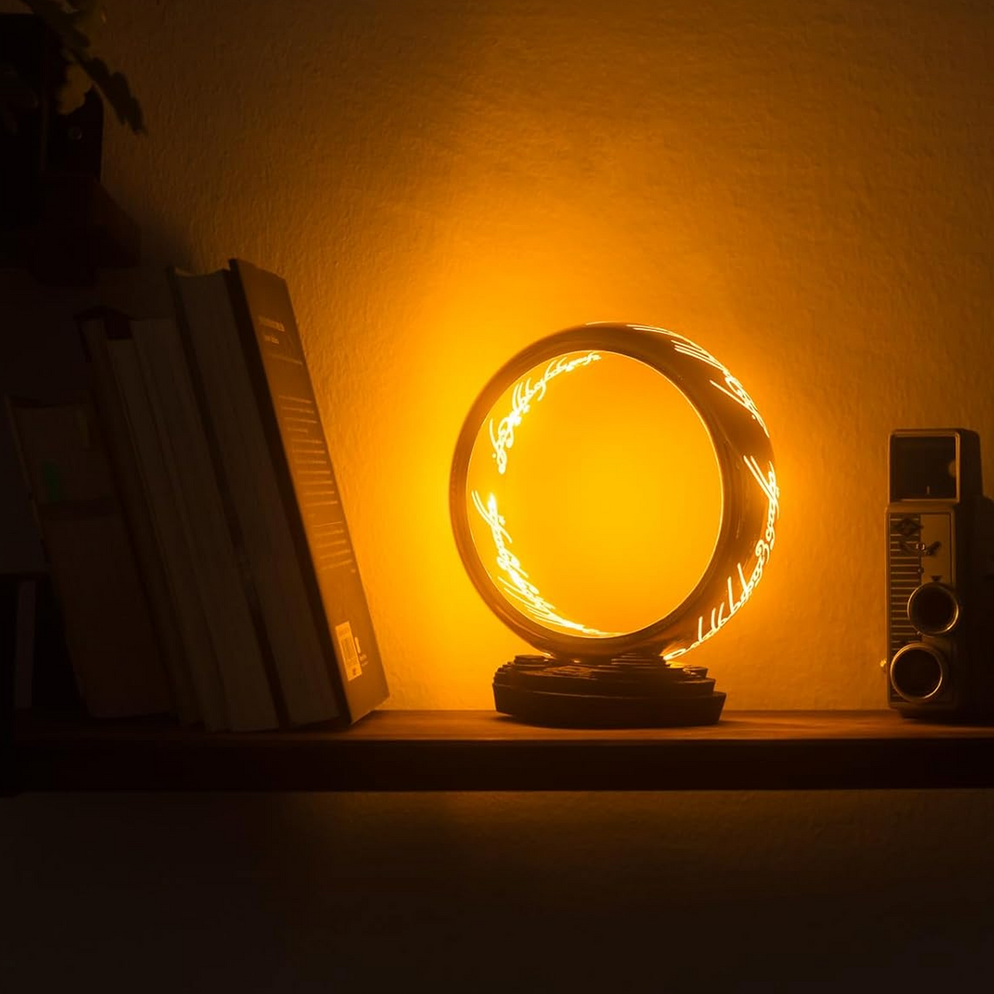 The Lord of the Rings The One Ring Table Lamp Lit up on a Bookshelf | Happy Piranha