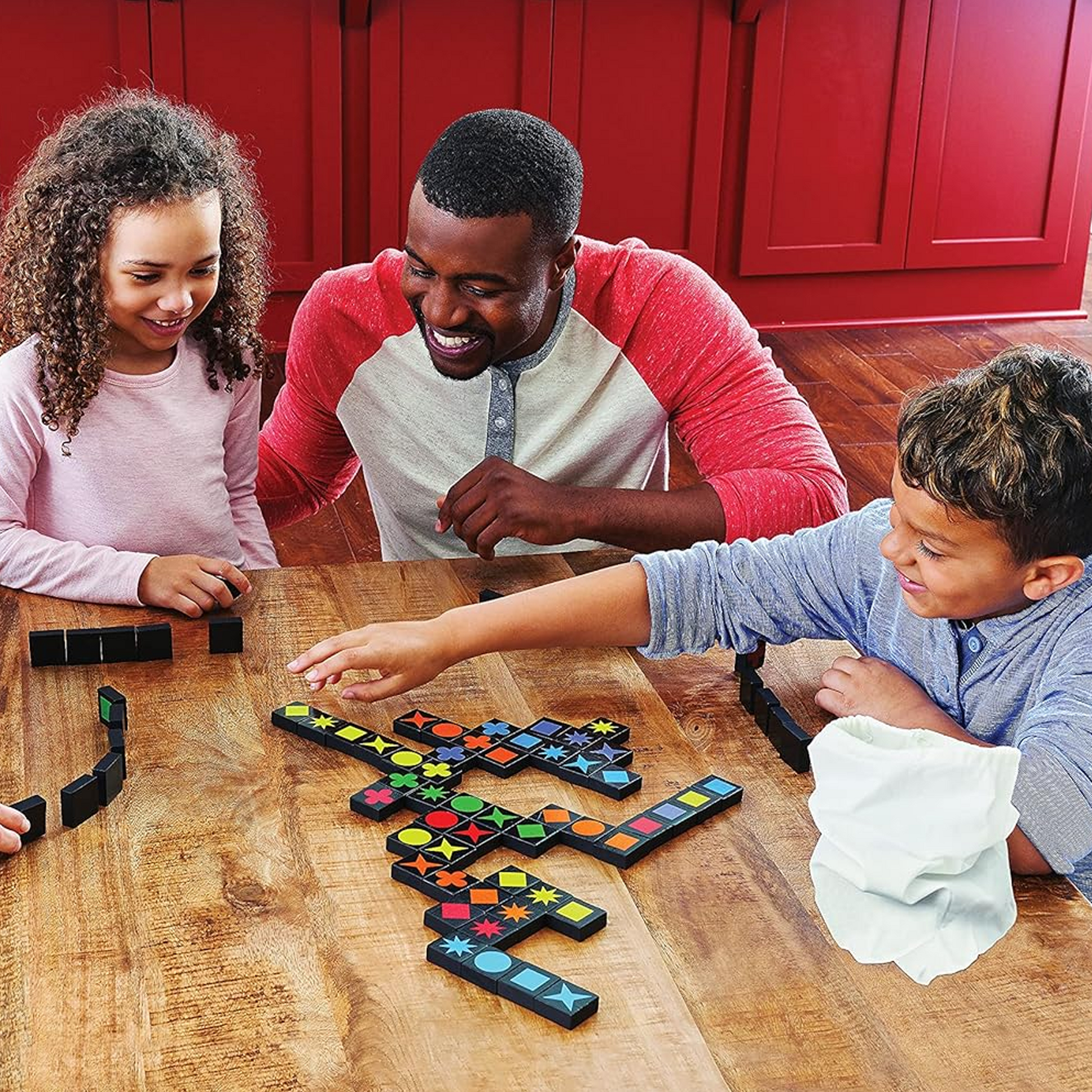 Qwirkle - Travel Size Board Game Being Played by a Family | Happy Piranha