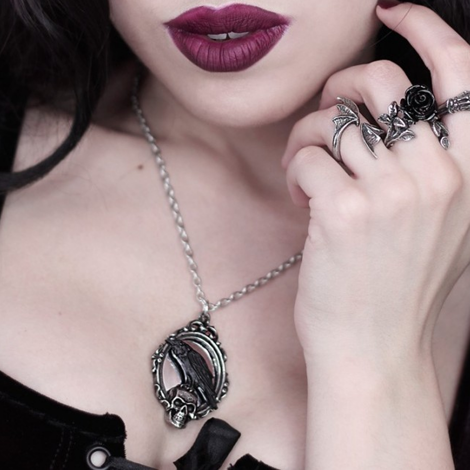 Close up of a Woman With Dark Lipstick and Gothic Rings Wearing the Reflections of Poe - Black Raven Necklace | Happy Piranha