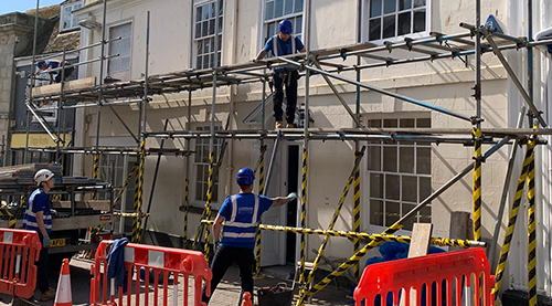 Scaffolders working on the outside of what will be Happy Piranha café.