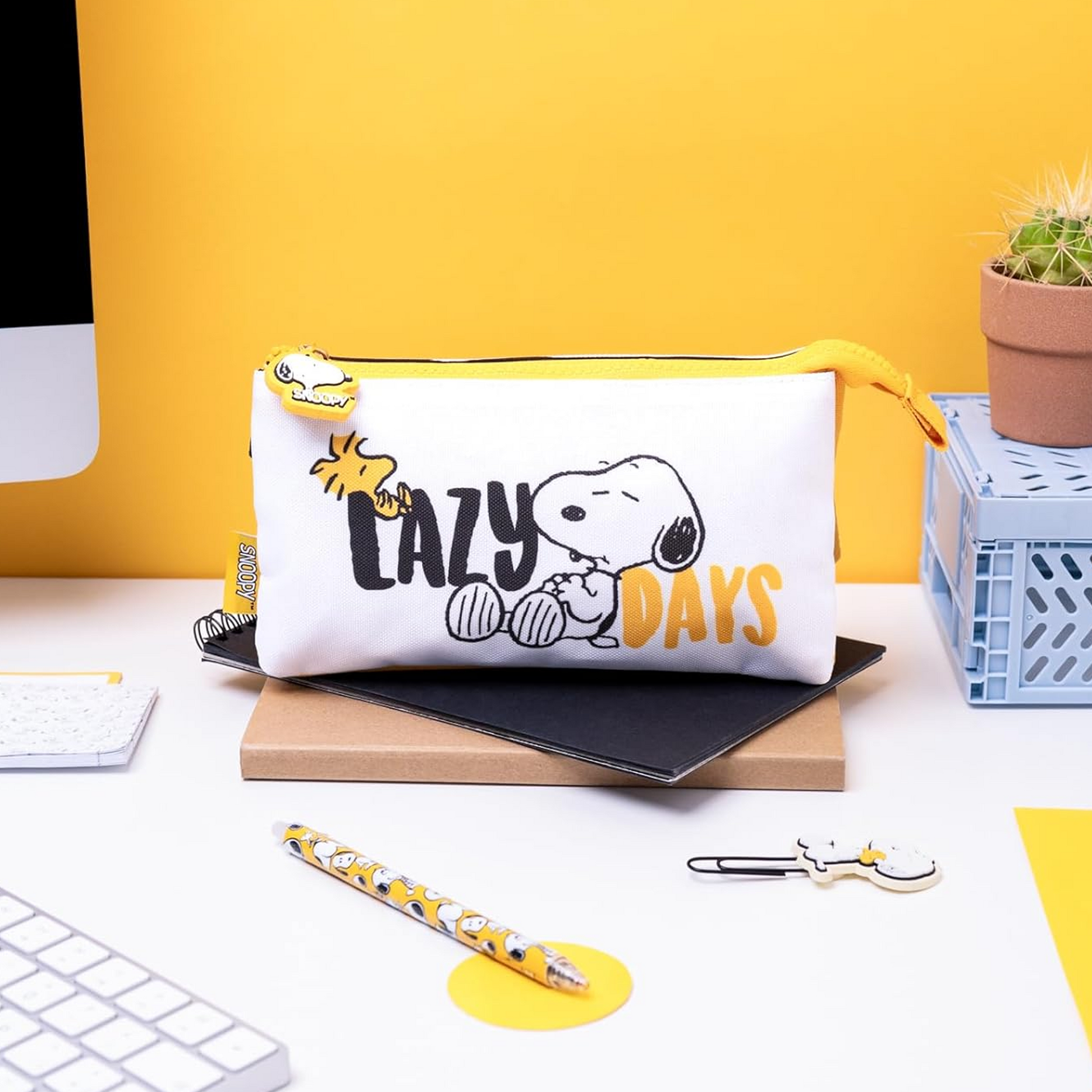 Snoopy & Woodstock 'Lazy Days' Multi-Compartment Pencil Case on a Desk with a Yellow Wall Behind (Front) | Happy Piranha