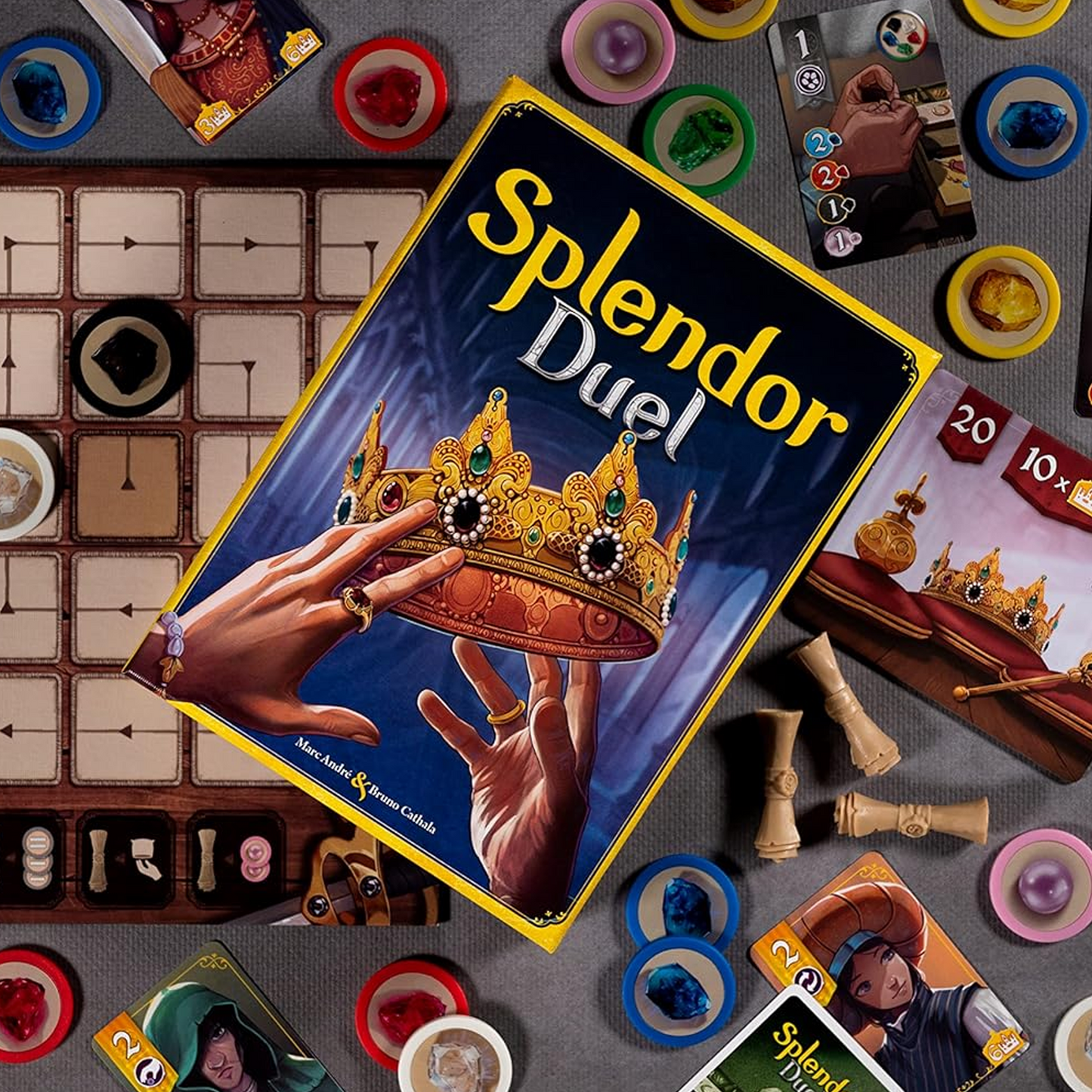 Splendor Duel Board Game Box with a Variety of Colourful Game Components Behind, Viewed form Above| Happy Piranha
