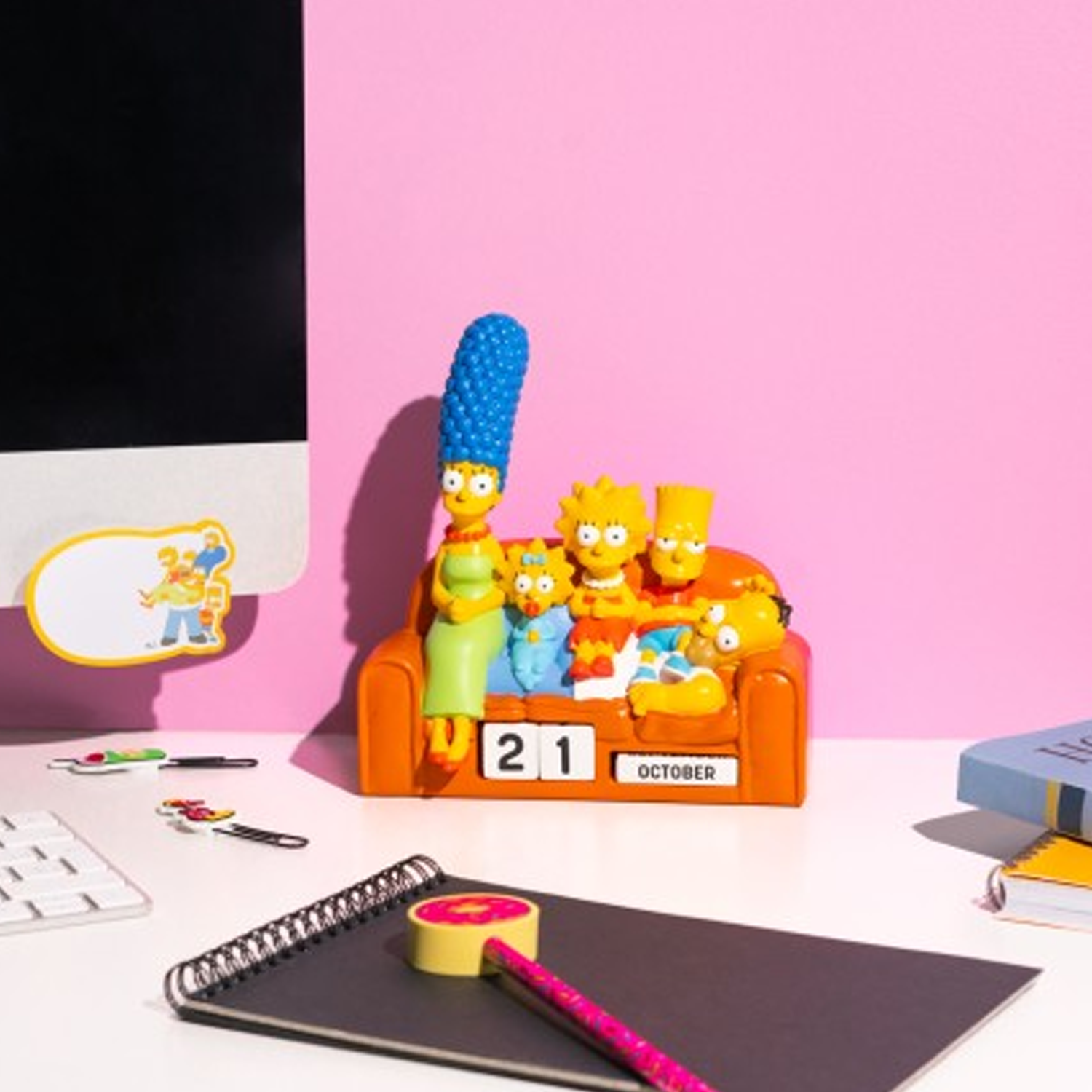 The Simpsons Family Sofa Scene: 3D Perpetual Calendar on a White Desk Next to Some Stationary, With a Pink Wall Behind | Happy Piranha