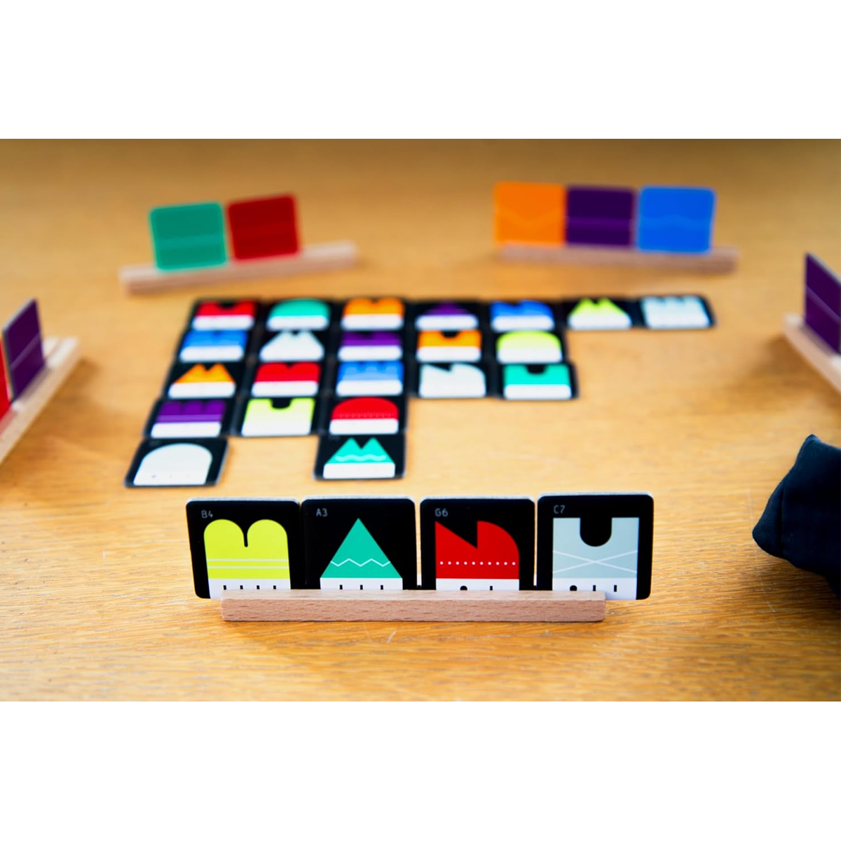 Town 77 Board Game (Being Played on a Wooden Table) on a White Background | Happy Piranha