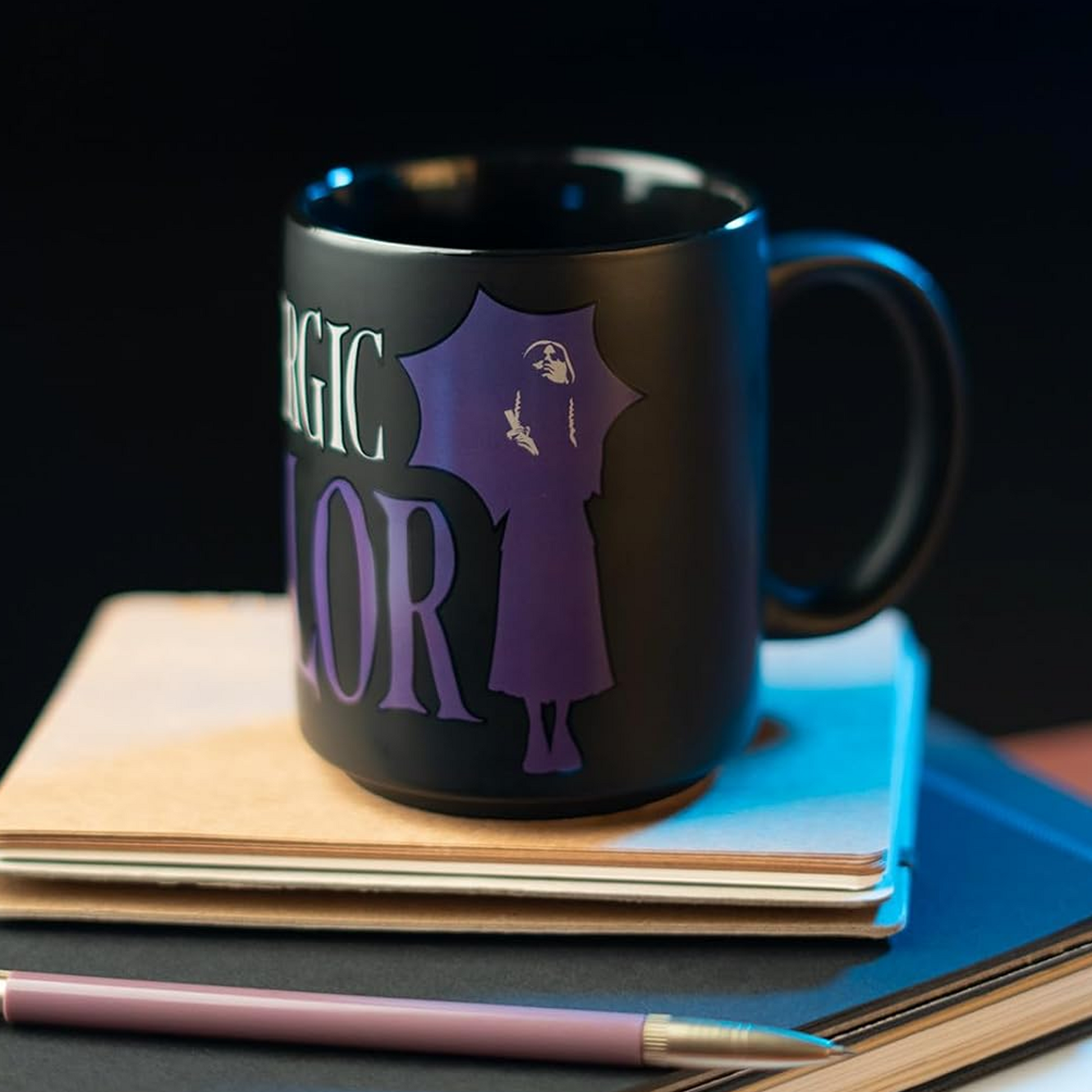 Wednesday Adams 'I'm Allergic to Colour' Ceramic Mug on top of Some Books | Happy Piranha