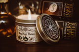 Polyjuice potion candle with  lid off and flame burning by Harry Potter books