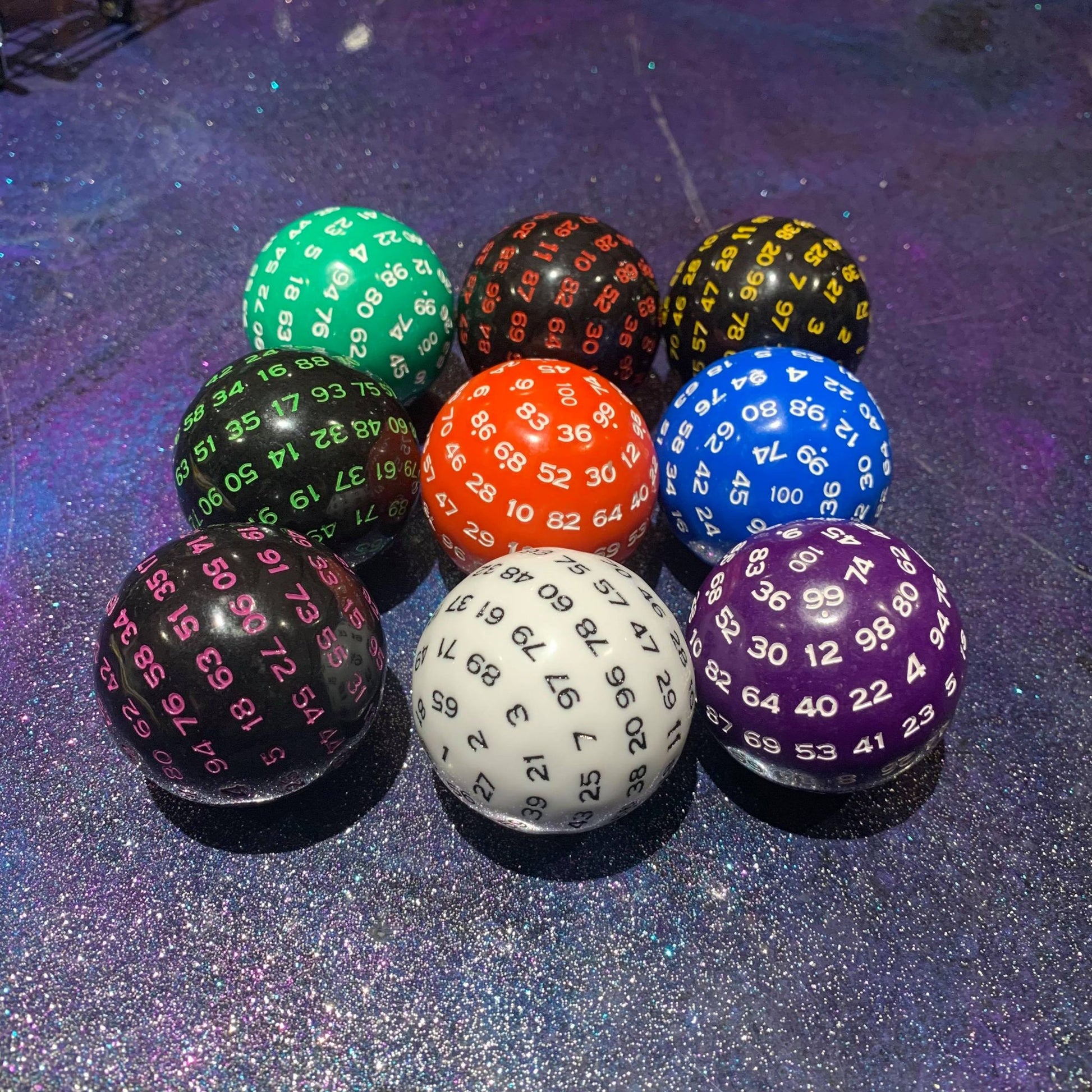 9 different colour of 100 sided dice in a row | Happy Piranha