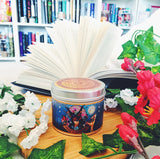 Iskari blood and moonlight candle with lid on and open book.