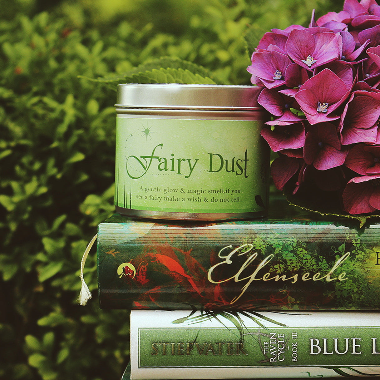Fairy Dust scented candle on a stack of books | Happy Piranha.