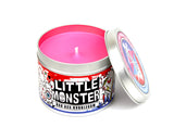Little monster scented candle with lid off and pink wax.
