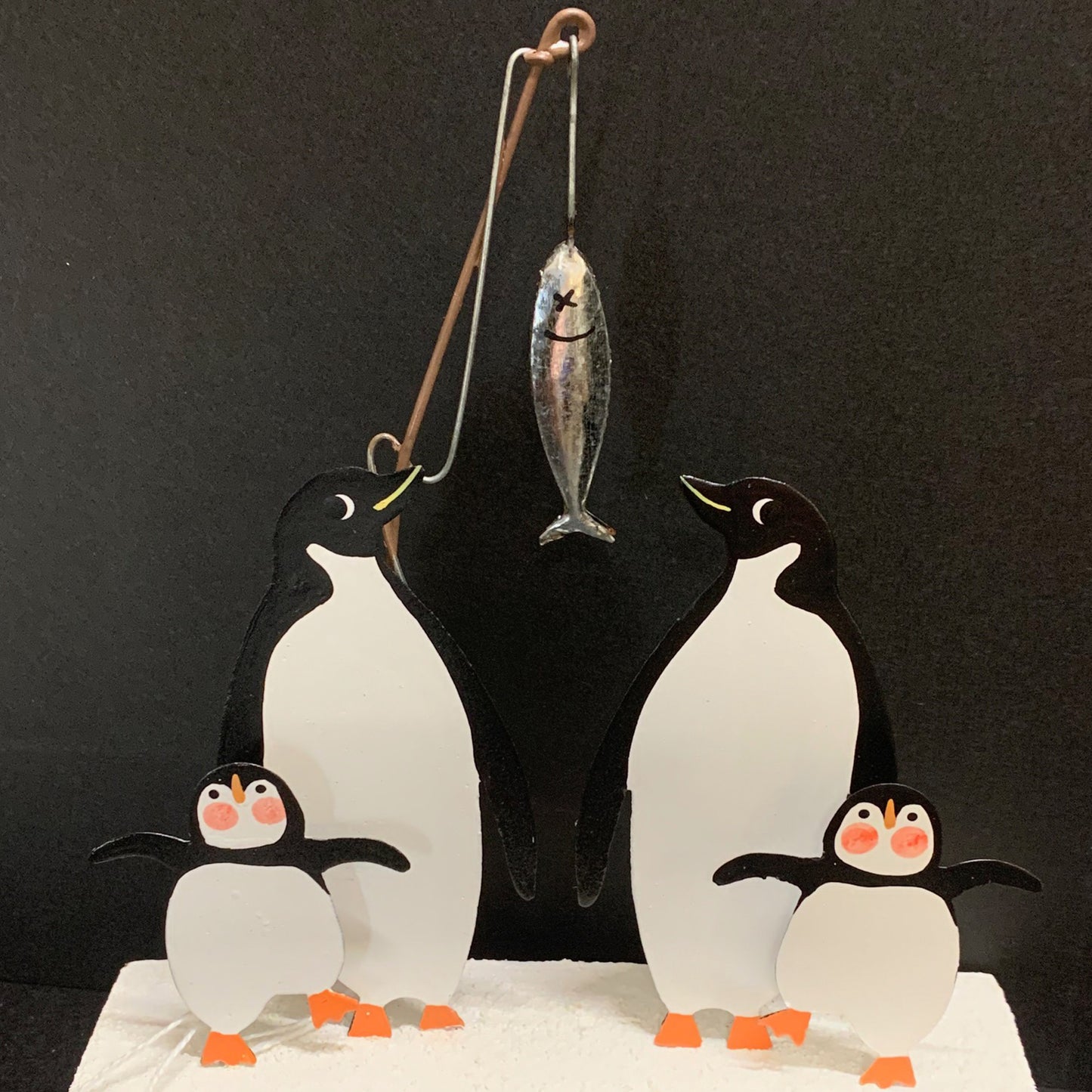 Fishing Penguin Family: Christmas Decoration on a Black Background | Happy Piranha