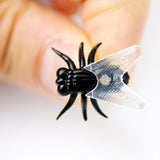 Fly Shaped Drawing Pins in a Person's Hand | Happy Piranha