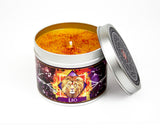 Leo zodiac constellation scented candle with lid off and orange wax.
