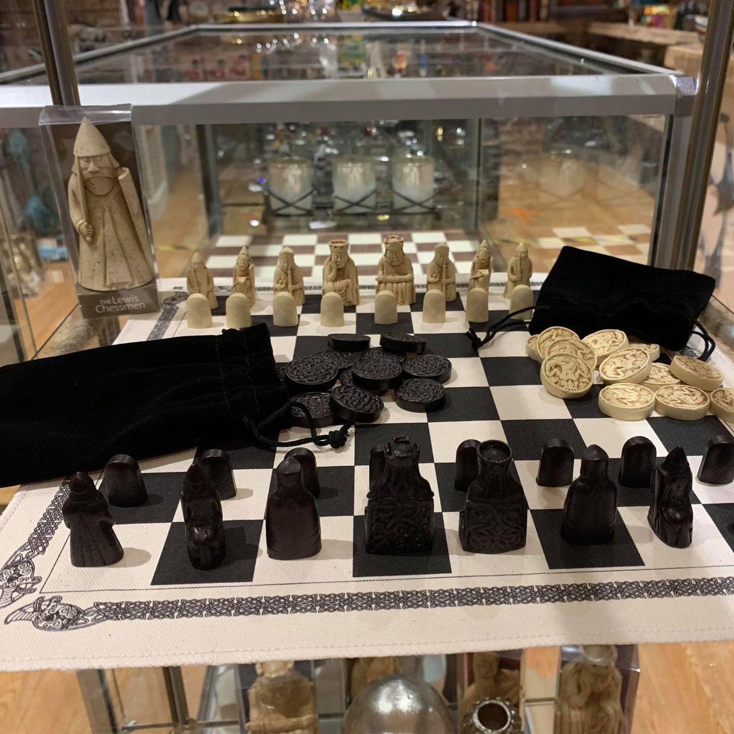 The Lewis Chessmen: Historical Chess ad Draughts Set Reproduction Close-up in a Display Case | Happy Piranha