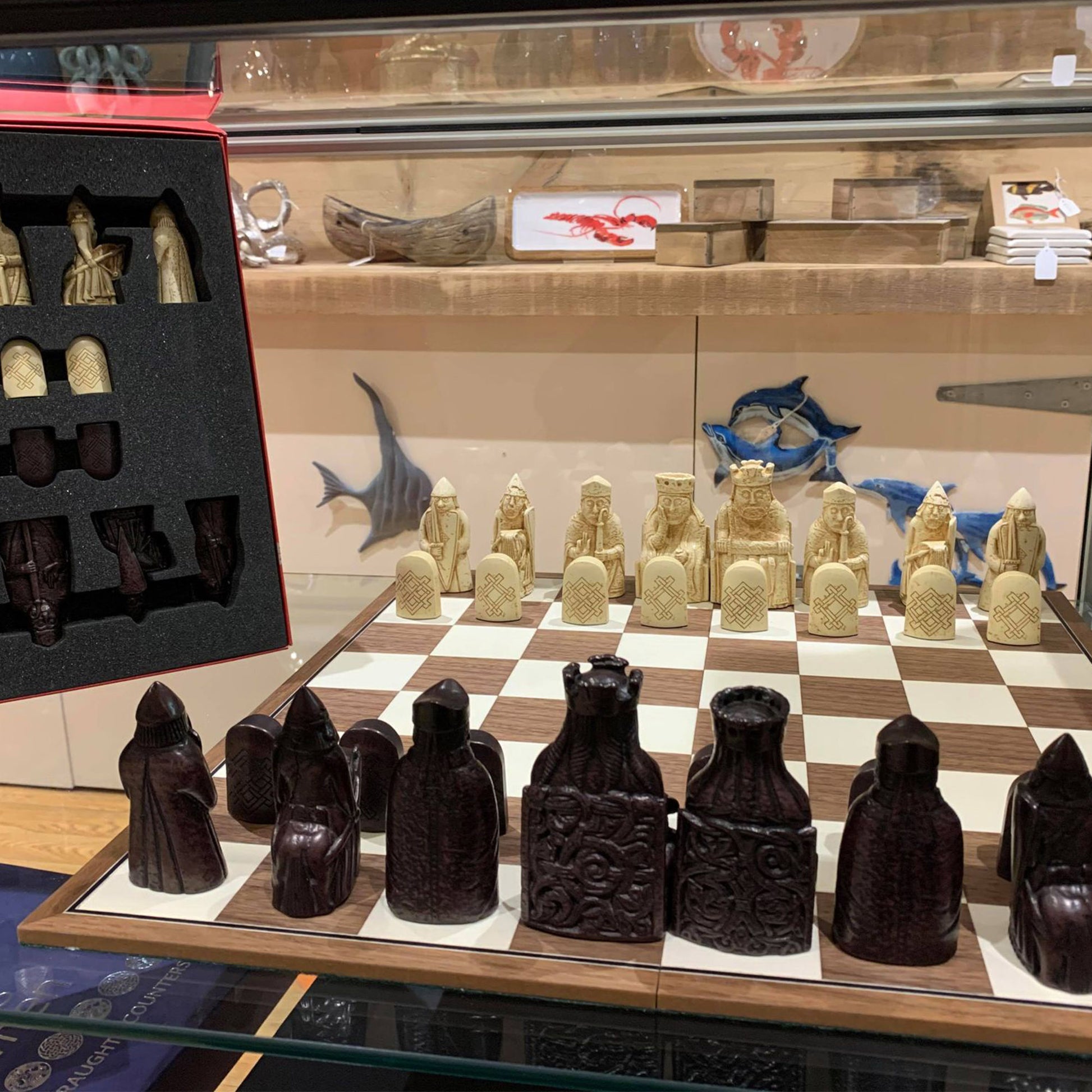 The Lewis Chessmen: Historical Chess Set Reproduction (Midsized) Close-up in a Display Case|  Happy Piranha