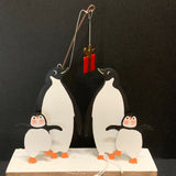 Penguins Fishing for Gifts: Christmas Decoration on a Black Background | Happy Piranha