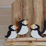 Puffins Sitting On A Coastal Groin Wood & Metal Ornament close up view | Happy Piranha